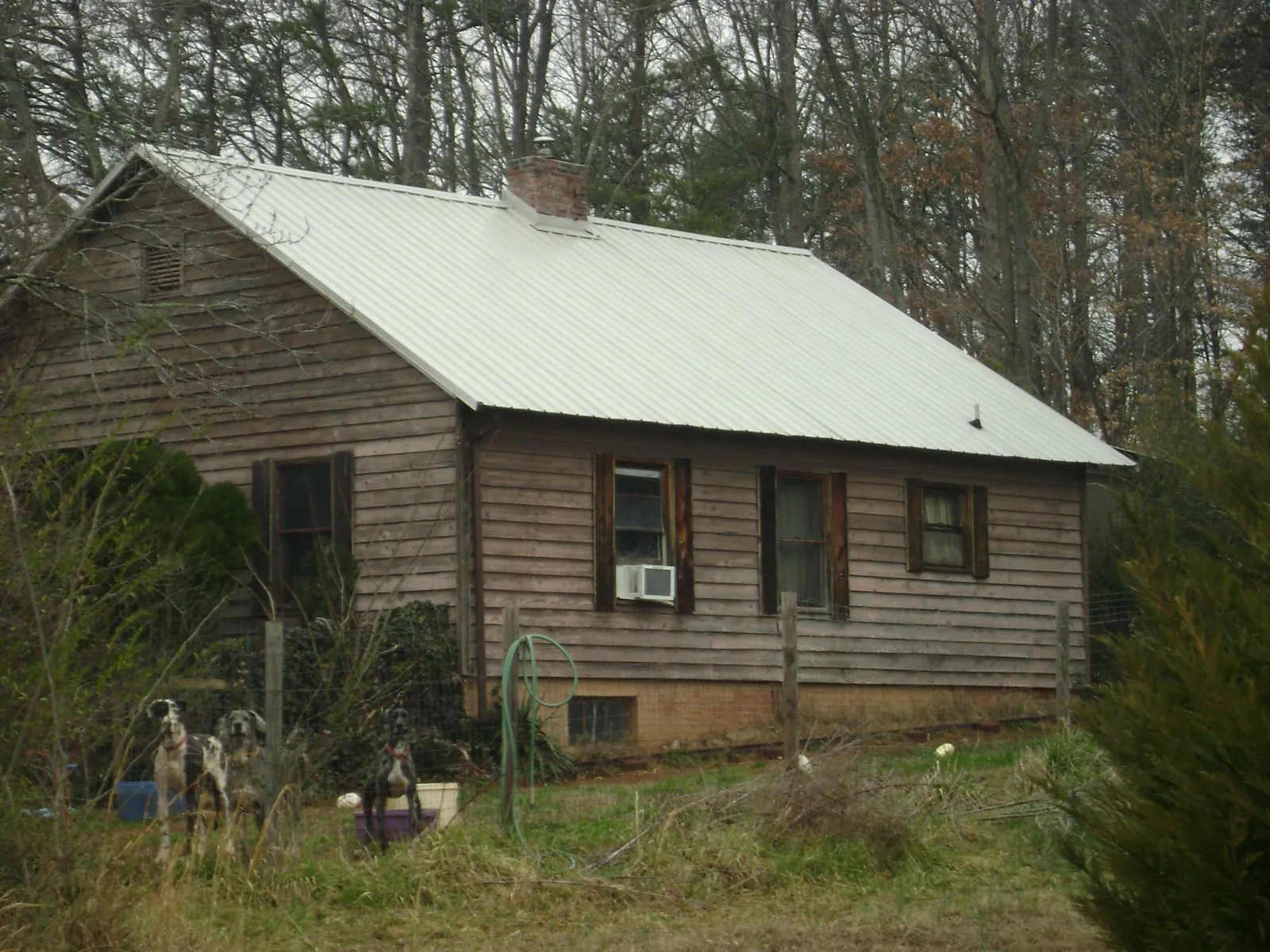 White metal roof on an old wood sided farmhouse, from a Metal Roof Installation job in Northfield